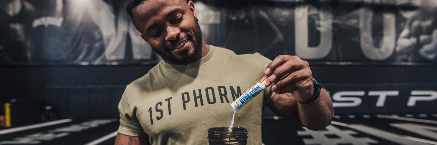 Man Pouring 1st Phorm Hydration Stick into Water