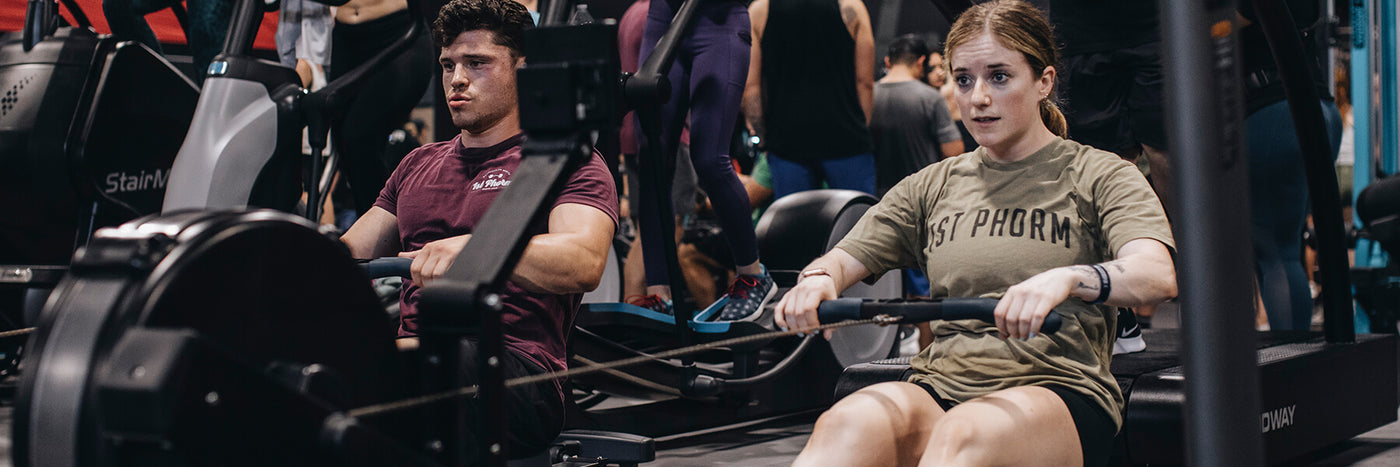 Two People Using Row Machines