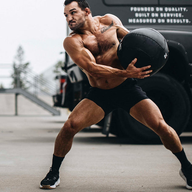 Michael Chandler throws wall ball exercising
